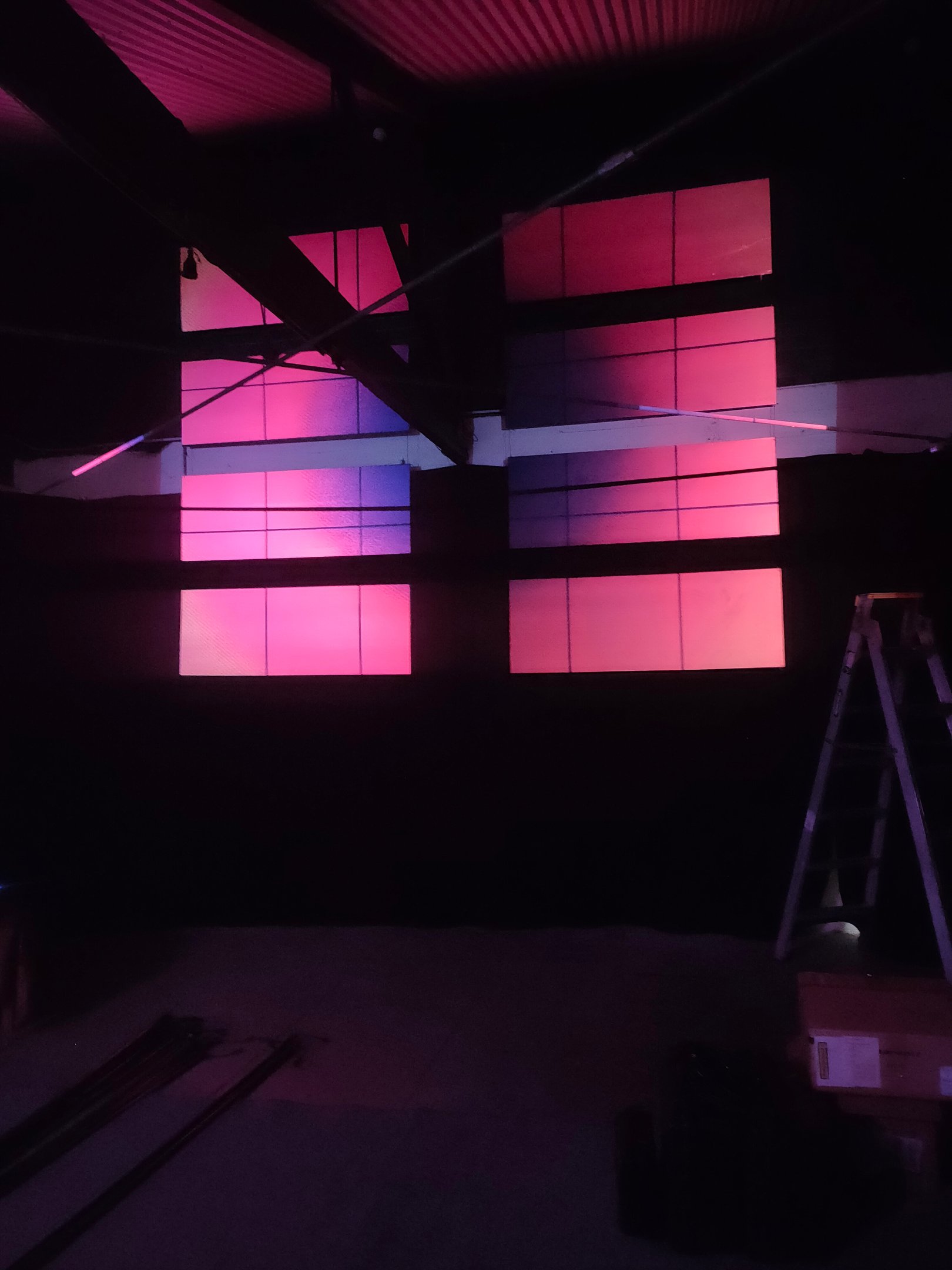 Ceiling panels washed in pink and violet light