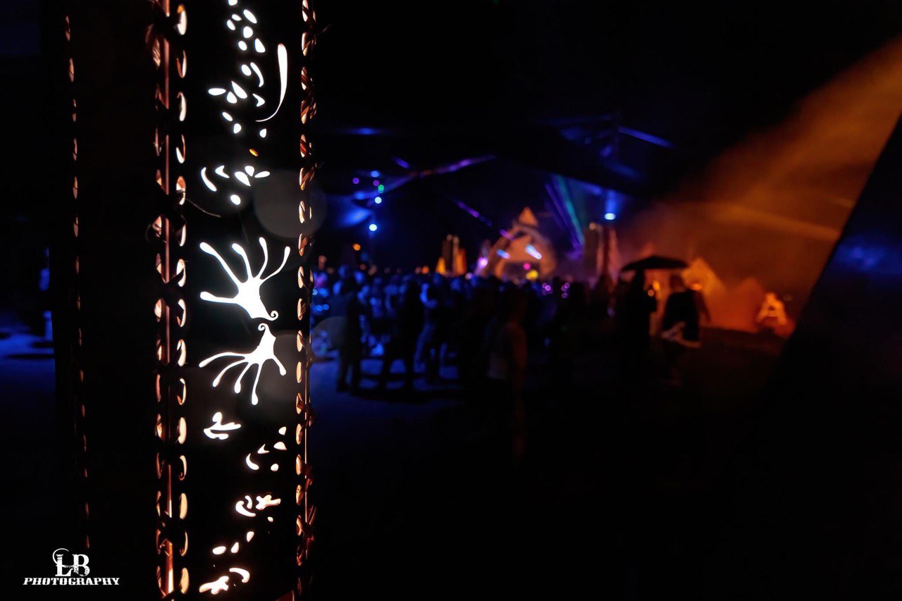 Laser-cut light patterns glowing on a pole installation